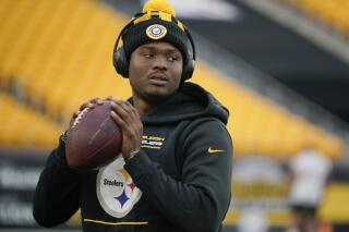 FILE - Pittsburgh Steelers quarterback Dwayne Haskins warms up before an NFL football game against the Baltimore Ravens, Dec. 5, 2021, in Pittsburgh. Haskins was legally drunk and had taken drugs before he was fatally struck by a dump truck while walking on a Florida interstate highway last month, an autopsy report released Monday, May 23, 2022, concluded. (AP Photo/Gene J. Puskar, File)