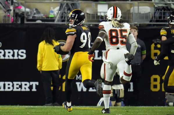 Pittsburgh Steelers linebacker T.J. Watt (90) returns a recovered fumble for a touchdown past Cleveland Browns tight end David Njoku (85) during the second half of an NFL football game Monday, Sept. 18, 2023, in Pittsburgh. (AP Photo/Gene J. Puskar)