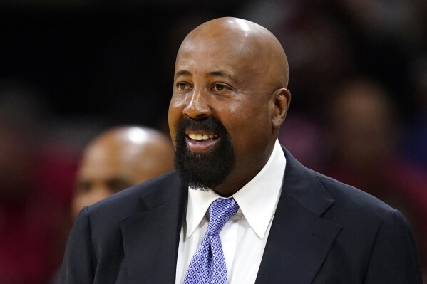 FILE - Indiana head coach Mike Woodson smiles on the sideline during the first half of an NCAA college basketball game against Iowa, Thursday, Jan. 5, 2023, in Iowa City, Iowa. Woodson's first two successful seasons made him another $1 million. The school athletic department announced Friday, AUg. 18, 2023, that Woodson has been given a pay raise, giving him the Big Ten's third-highest annual average salary at $4.2 million. (AP Photo/Charlie Neibergall, File)
