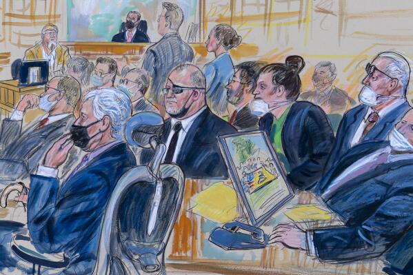 This artist sketch depicts the trial of Oath Keepers leader Stewart Rhodes and four others charged with seditious conspiracy in the Jan. 6, 2021, Capitol attack, in Washington, Thursday, Oct. 6, 2022. Shown above are, witness John Zimmerman, who was part of the Oath Keepers’ North Carolina Chapter, seated in the witness stand, defendant Thomas Caldwell, of Berryville, Va., seated front row left, Oath Keepers leader Stewart Rhodes, seated second left with an eye patch, defendant Jessica Watkins, of Woodstock, Ohio, seated third from right, Kelly Meggs, of Dunnellon, Fla., seated second from right, and defendant Kenneth Harrelson, of Titusville, Fla., seated at right. Assistant U.S. Attorney Kathryn Rakoczy is shown in blue standing at right before U.S. District Judge Amit Mehta. (Dana Verkouteren via AP)