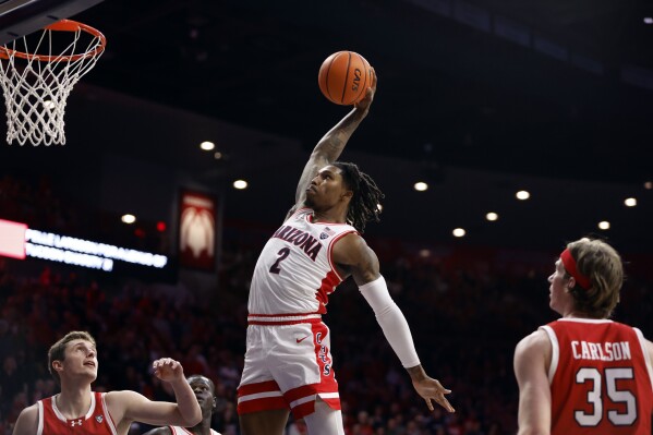 FILE - Arizona guard Caleb Love dunks against Utah during the second half of an NCAA college basketball game Saturday, Jan. 6, 2024, in Tucson, Ariz. (AP Photo/Chris Coduto, File)