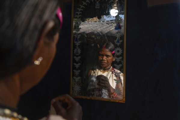 A woman, from the Durua Indigenous community, prepares to take part in the Chaitra Parab festival, a monthlong harvest celebration, in Hatipakna village, Koraput district, in India's eastern state of Odisha, Thursday, April 17, 2025. (AP Photo/Rafiq Maqbool)