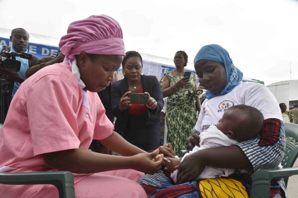 A health worker administers the malaria vaccine Oxford-Serum R21 to a child in Abidjan, Ivory Coast, Monday, July 15, 2024. (AP Photo/Diomande Ble Blonde)