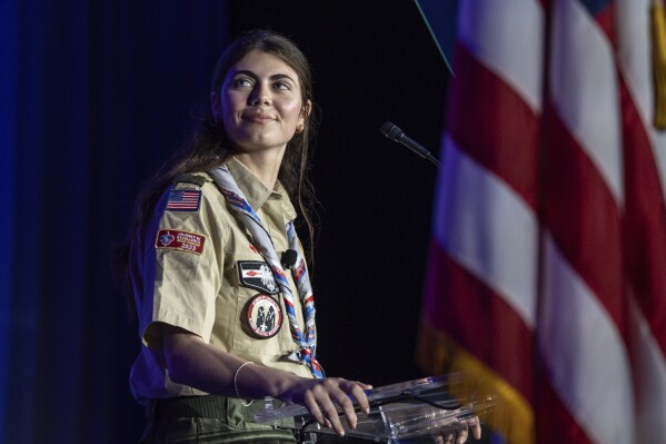 Selby Chipman, 20-years-old, speaks to the Boys Scouts of America annual meeting in Orlando, Fla. Tuesday, May 7, 2024. Chipman, a student at the University of Missouri, is and Inaugural female Eagle Scout and the Assistant Scoutmaster for an all girls troop 8219 in Oak Ridge, NC. The Boy Scouts of America is changing its name to Scouting America for the first time in its 114-year history. (AP Photo/Kevin Kolczynski)