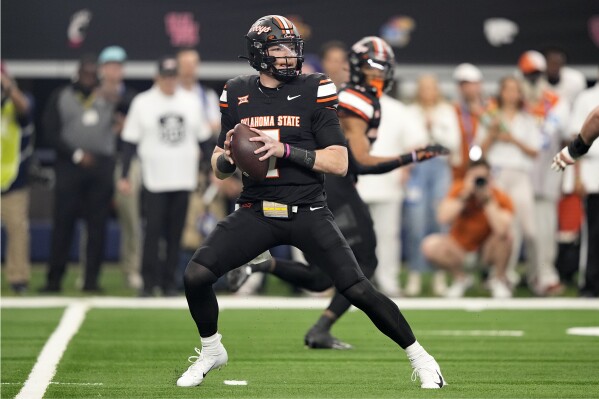 Oklahoma State quarterback Alan Bowman (7) drops back to pass in the first half of the Big 12 Conference championship NCAA college football game in Arlington, Texas, Saturday, Dec. 2, 2023. (AP Photo/Tony Gutierrez)