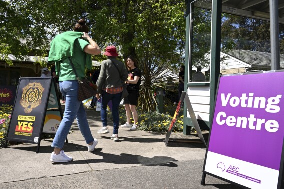 People arrive at a voting centre for the Indigenous Voice to Parliament referendum in Melbourne, Monday, Oct. 2, 2023. Early voting began in some parts of Australia for a referendum to ask if the voice should be enshrined in Australia's constitution as a mechanism for Indigenous people to advise Parliament on policies that affect their lives. (Joel Carrett/AAP Image via AP)