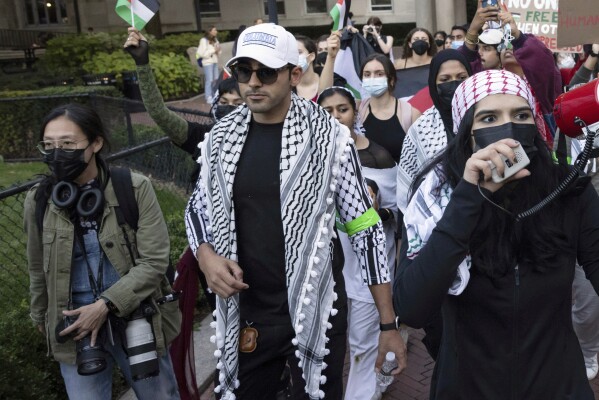 Mohsen Mahdawi, center, looks on during a pro-Palestinian protest at Columbia University, Thursday, Oct. 12, 2023, in New York. (AP Photo/Yuki Iwamura, File)