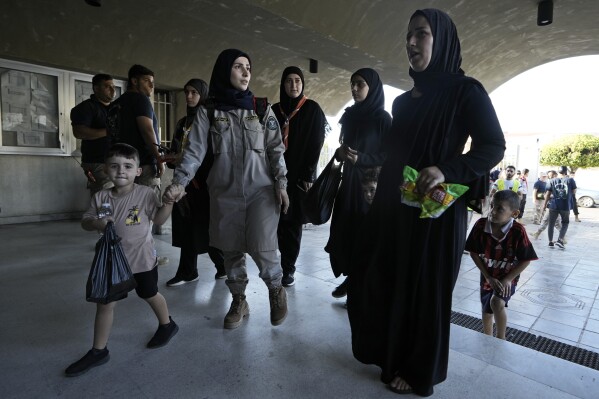 Thousands flee southern Lebanon in search of safety and shelter | AP News