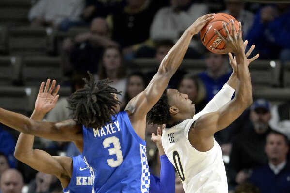 Kentucky guard Tyrese Maxey (3) blocks Vanderbilt guard Saben Lee's (0) shot from behind during the first half of an NCAA college basketball game Tuesday, Feb. 11, 2020, in Nashville, Tenn. (AP Photo/Mark Zaleski)