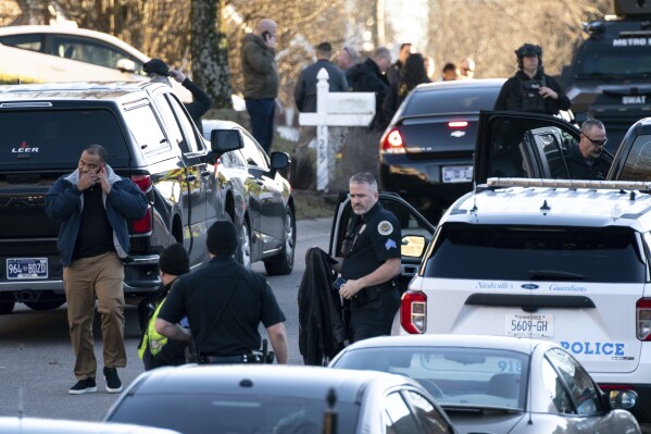 FILE - Nashville police gather at the scene after a Metro Nashville police officer shot and killed Grammy-winning sound engineer Mark Capps while at his home to arrest him on warrants, Jan. 5, 2023, in Nashville, Tenn. Newly released investigative files in the police shooting death of Capps reveal there was an armed Tennessee Bureau of Investigation officer in the home when Capps began threatening his family with guns on Jan. 5. (Andrew Nelles/The Tennessean via AP, File)