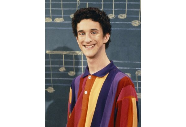 This image released by NBC shows actor Dustin Diamond as Samuel Powers, better known as Screech" from the 1990's series "Saved by the Bell." Diamond died Monday after a three-week fight with carcinoma, according to his representative. He was 44. Diamond was hospitalized last month in Florida and his team disclosed later he had cancer. (Paul Drinkwater/NBCU Photo Bank via AP)