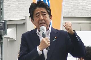 In this image from a video, Japan’s former Prime Minister Shinzo Abe makes a campaign speech in Nara, western Japan shortly before he was shot Friday, July 8, 2022. Former Japanese Prime Minister Shinzo Abe, a divisive arch-conservative and one of his nation's most powerful and influential figures, has died after being shot during a campaign speech Friday in western Japan, hospital officials said.(Kyodo News via AP)
