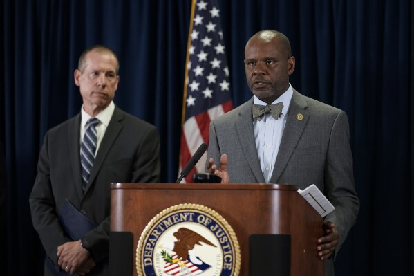 U.S. Attorney for the Northern District of California Ismail J. Ramsey, right, speaks to reporters during a press conference to announce federal authorities have charged 10 current and former Northern California police officers in a corruption investigation Thursday, Aug. 17, 2023, in San Francisco. Arrest warrants were served Thursday in California, Texas and Hawaii. (AP Photo/Godofredo A. Vásquez)