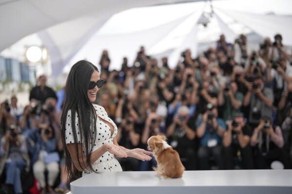 Demi Moore poses with her dog Pilaf for photographers at the photo call for the film 'The Substance' at the 77th international film festival, Cannes, southern France, Monday, May 20, 2024. (Photo by Andreea Alexandru/Invision/AP)