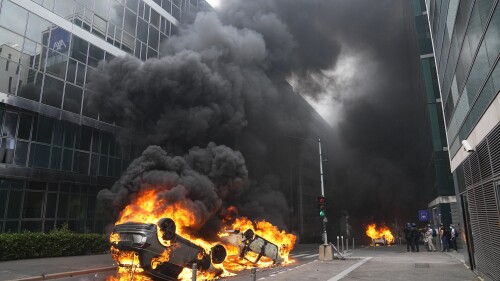 FILE - Cars burn after a march for Nahel, Thursday, June 29, 2023 in Nanterre, outside Paris. The killing of 17-year-old Nahel during a traffic check Tuesday, captured on video, shocked the country and stirred up long-simmering tensions between young people and police in housing projects and other disadvantaged neighborhoods around France. After more than 3,400 arrests and signs that the violence is now abating, France is once again facing a reckoning (AP Photo/Michel Euler, File)