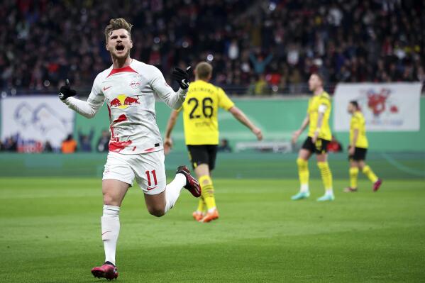 Leipzig's Timo Werner, left, celebrates after scoring to 1-0 during the quarterfinal DFB Cup soccer match between RB Leipzig and Borussia Dortmund at the Red Bull Arena in Leipzig, Germany, Wednesday April 5, 2023. (Jan Woitas/dpa via AP)