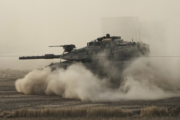 An Israeli tank moves in a staging area in southern Israel, near the border with Gaza, Friday, May 16, 2025. (AP Photo/Maya Alleruzzo)