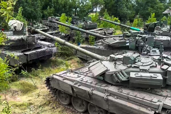 In this photo released by Russian Defense Ministry Press Service on Wednesday, July 12, 2023, Tanks belonging to Russia's Wagner military contractor are parked ahead of their handover to the Russian military at an undisclosed location. The Russian Defense Ministry said that Wagner Group is completing the handover of its weapons to the Russian military. The move follows Wagner's short-lived mutiny last month that challenged the Kremlin. (Russian Defense Ministry Press Service via AP)