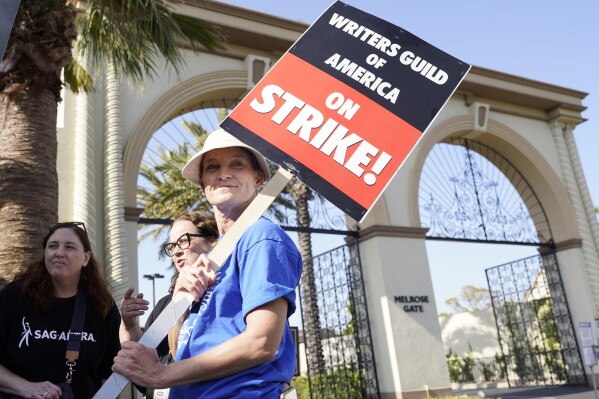 FILE - Meredith Stiehm, president of the Writers Guild of America West, pickets outside Paramount Pictures studio, Monday, May 8, 2023, in Los Angeles. Negotiations between striking screenwriters and Hollywood studios are set to resume Wednesday, the latest attempt to bring an end to pickets that have brought film and television productions to a halt. The two sides have been divided on issues of pay, the size of writing staffs on shows and the use of artificial intelligence in how scripts are created. (AP Photo/Chris Pizzello, File)