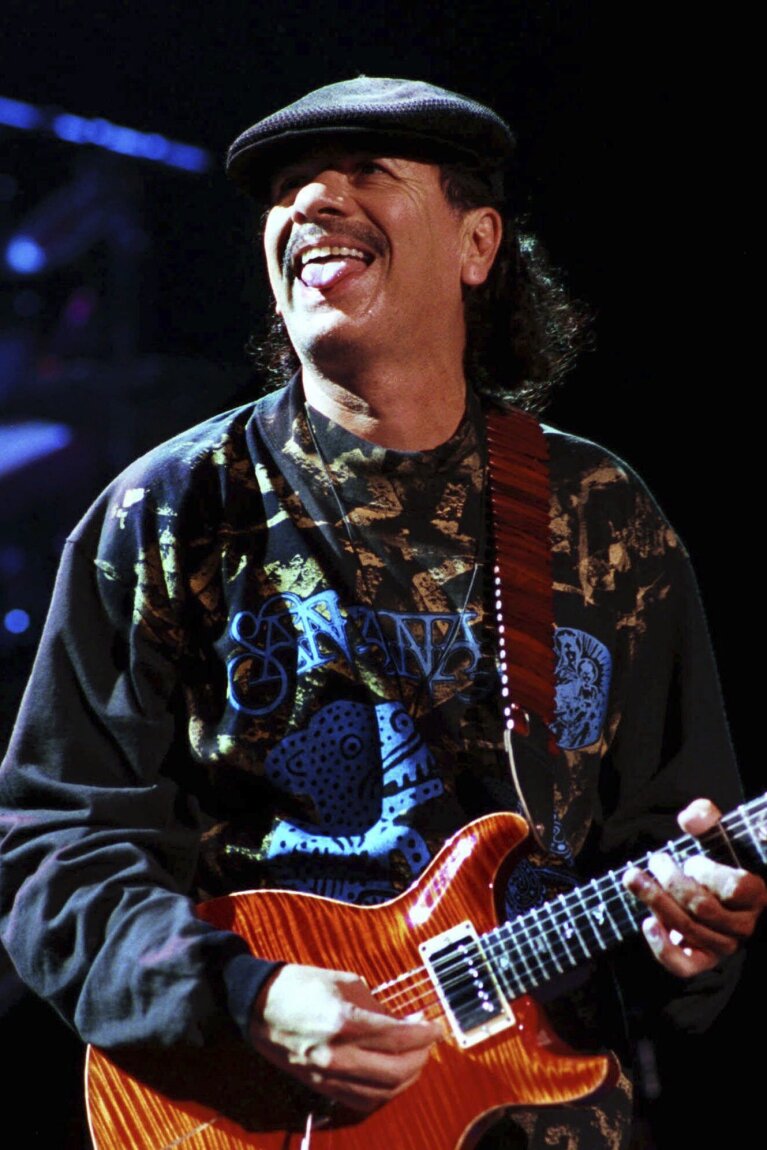 FILE - Carlos Santana performs in Clarkston, Mich., on June 12, 1999. A new documentary "Carlos" covers the music career of the multi-Grammy Award-winning artist. (AP Photo/Paul Warner, File)
