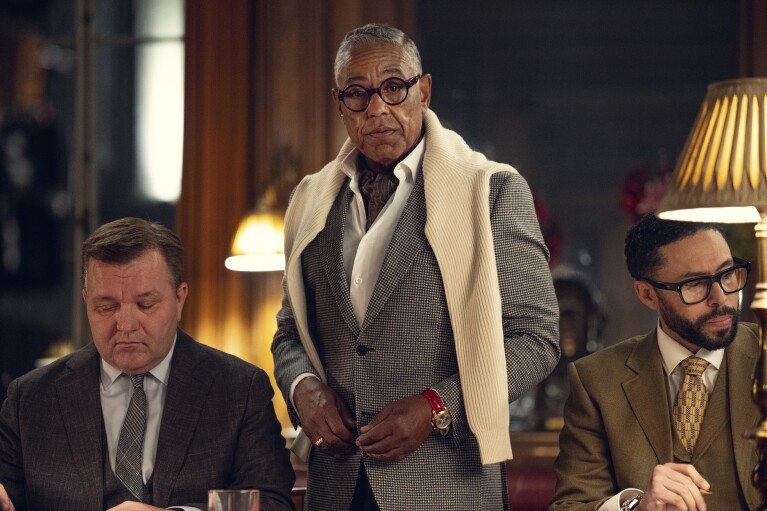 This image released by Netflix shows Giancarlo Esposito, center, from the Netflix series "The Gentlemen." (Kevin Baker/Netflix via AP)