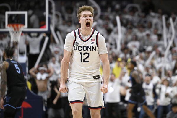 UConn guard Cam Spencer (12) reacts in the second half of an NCAA college basketball game against Villanova, Saturday, Feb. 24, 2024, in Storrs, Conn. (AP Photo/Jessica Hill)