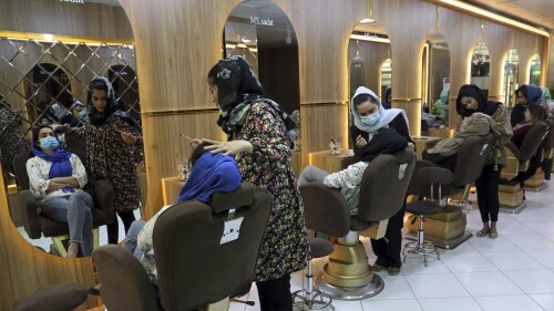 FILE- Beauticians put makeup on customers at Ms. Sadat's Beauty Salon in Kabul, Afghanistan, Sunday, April 25, 2021. The one-month dateline given to women beauty salons ban in Afghanistan ended Tuesday, July 25, 2023. Taliban say that beauty salons must stop their activities otherwise their licenses will be cancelled. Sadiq Akif Mahjer, the spokesman for the Taliban-run Virtue and Vice Ministry says Tuesday that if they do not obey the orders of the ministry, their licenses will be cancelled by the municipality. (AP Photo/Rahmat Gul, File)