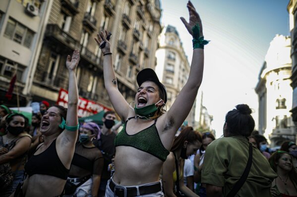 Abortion-rights activists rally outside Congress as lawmakers debate a bill on its legalization, in Buenos Aires, Argentina, Thursday, Dec. 10, 2020.  The lower house is expected to vote on a legal abortion bill presented by President Alberto Fernández. (AP Photo/Natacha Pisarenko)
