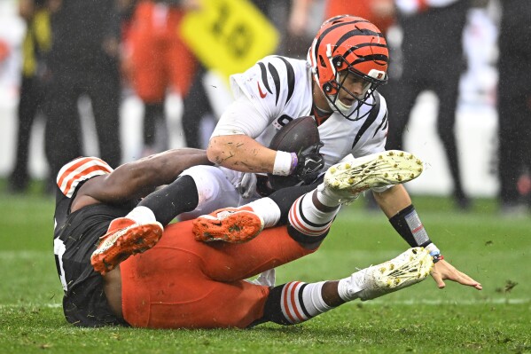 Cincinnati Bengals quarterback Joe Burrow (9) is sacked by Cleveland Browns defensive end Myles Garrett (95) during the second half of an NFL football game Sunday, Sept. 10, 2023, in Cleveland. (AP Photo/David Richard)