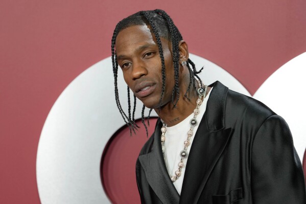 FILE - Travis Scott arrives at GQ's Men of the Year Party in Los Angeles on Nov. 16, 2023. Scott was arrested by Miami Beach police early Thursday on misdemeanor charges of trespassing and public intoxication. (AP Photo/Chris Pizzello, File)