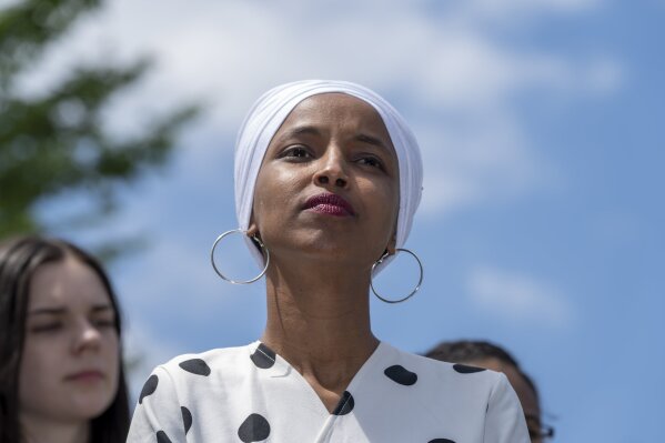Rep. Ilhan Omar, D-Minn., listens as she joins Democratic presidential candidate, Sen. Bernie Sanders, I-Vt., to call for legislation to cancel all student debt, at the Capitol in Washington, Monday, June 24, 2019. (AP Photo/J. Scott Applewhite)