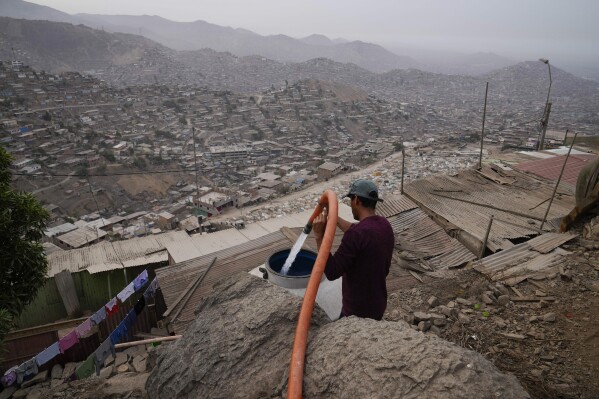 A resident fills his water tank at the Pamplona Alta hilltop neighborhood in Lima, Peru, March 8, 2024. (AP Photo/Martin Mejia)