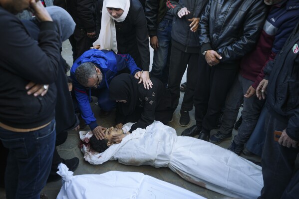 Palestinians mourn their relatives killed in the Israeli bombardments of the Gaza Strip in front of the morgue of the Al Aqsa Hospital in Deir al Balah, on Thursday, Feb. 29, 2024. (AP Photo/Adel Hana)