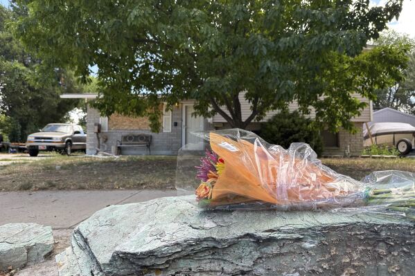 Flowers laid by firefighters are seen in front of the home of Craig Robertson, Thursday, Aug 10, 2023, in Provo, Utah. Robertson was killed by FBI agents Wednesday during a confrontation after making violent threats against President Joseph Biden and other public officials. (AP Photo/Sam Metz)