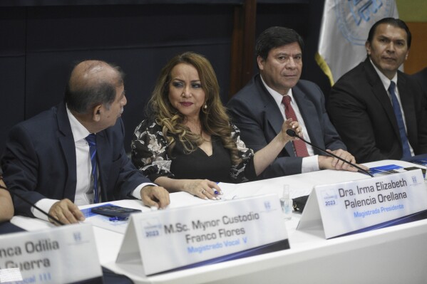 Supreme Electoral Tribunal magistrates hold a press conference in Guatemala City, Wednesday, July 12, 2023. The tribunal certified presidential election results, sending candidates Sandra Torres and Bernardo Arévalo to an Aug. 20 runoff, while the Attorney General's Office announced that Arevalo´s party had been suspended. (AP Photo/Wilder Lopez)