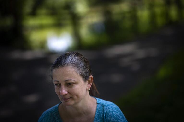 Olga Lopatkina speaks to The Associated press during an interview in a park in Loue, western France, Saturday, July 2, 2022. She told herself every day that the war would end fast. It was the 21st century, after all. Instead, it edged closer. (AP Photo/Jeremias Gonzalez)