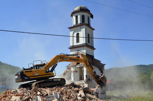 An orthodox church is demolished in Konjevic Polje, the village next to Srebrenica in Bosnia, Saturday, June 5, 2021. Bosnian authorities have demolished a Serbian Orthodox church illegally built on the land owned by a Bosniak woman after a 20-year-long legal battle that reached the European Court of Human Rights. Workers and construction machinery arrived at Fata Orlovic’s yard in the village of Konjevic Polje early Saturday. (AP Photo/Sladjan Vasic)