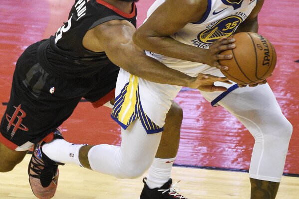 
              Houston Rockets guard Chris Paul, left, reaches for the ball held by Golden State Warriors forward Kevin Durant during the first half of Game 2 of the NBA basketball playoffs Western Conference finals Wednesday, May 16, 2018, in Houston. (AP Photo/Eric Christian Smith)
            