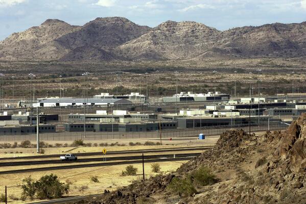 FILE - Arizona State Prison Complex-Lewis is shown on Jan. 20, 2004, in Buckeye, Ariz. A trial began on Monday, Nov. 1, 2021, in a lawsuit challenging the quality of health care for the more than 27,000 people incarcerated in Arizona's state-run prisons. The trial was called after a 6-year-old settlement resolving the case was thrown out by a judge who concluded the state showed little interest in making many of the improvements it promised under the deal. (AP Photo/Tom Hood, File)