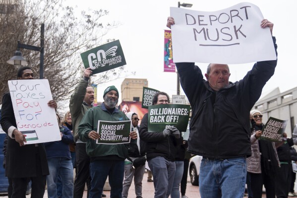 Demonstrators gather outside of the Edward A. Garmatz United States District Courthouse in Baltimore, on Friday, March 14, 2025, before a hearing regarding the Department of Government Efficiency's access to Social Security data. (AP Photo/Stephanie Scarbrough)