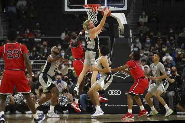 Providence's Noah Horchler (14) grabs a rebound on a shot by St. John's Esahia Nyiwe, third from left, during the first half of an NCAA basketball game on Saturday, Jan. 8, 2022, in Providence, R.I. (AP Photo/Stew Milne)