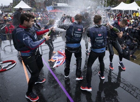 In this photo provided by SailGP, Emirates Great Britain SailGP Team, helmed by Giles Scott, celebrate after winning the Canada Sail Grand Prix in Halifax, Nova Scotia, Sunday, June 2, 2024. (Ricardo Pinto/SailGP via AP)