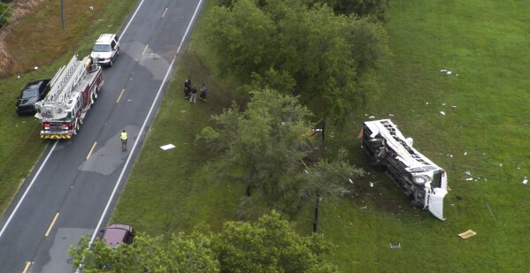 Emergency workers work the scene of a fatal bus crash carrying laborers that overturned Tuesday morning, May 14, 2024, in Ocala, Fla. (Doug Engle/Ocala Star-Banner via AP)