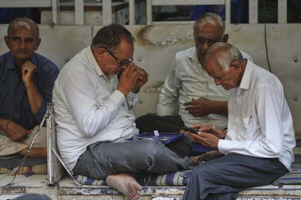 Diamond traders conduct business at a market in Surat, India, on April 14, 2025. (AP Photo/Ajit Solanki)
