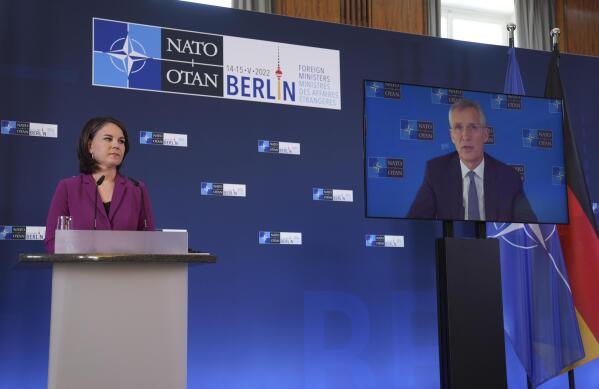 German Foreign Minister Annalena Baerbock listens to NATO Secretary General Jens Stoltenberg who speaks from a video screen during an informal meeting of the North Atlantic Council in Foreign Ministers' session in Berlin, Germany, Sunday, May 15, 2022. (AP Photo/Michael Sohn)