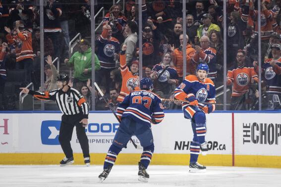 Edmonton Oilers' Ryan Nugent-Hopkins (93) and Leon Draisaitl (29) celebrate a goal against the Winnipeg Jets during the first period of an NHL hockey game Friday, March 3, 2023, in Edmonton, Alberta. (Jason Franson/The Canadian Press via AP)