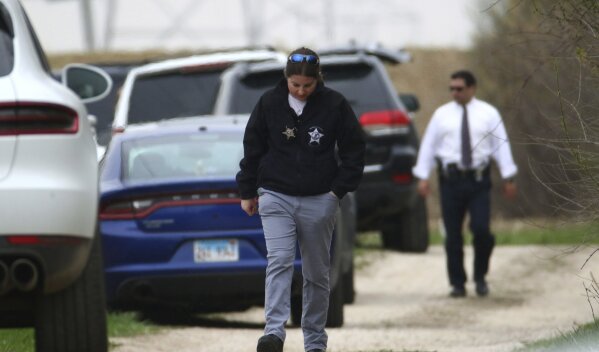 
              A McHenry County Coroner investigator walks to her vehicle at a wooded area off Dean Street Wednesday, April 24, 2019, in Woodstoc, Ill. 5-year-old Andrew "AJ" Freund was found at the location, and the boy's parents have been charged with his murder. (John J. Kim/Chicago Tribune via AP)
            