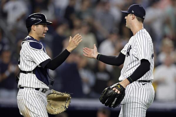 New York Yankees pitcher Clay Holmes, right, and Kyle Higashioka celebrate after the ninth inning of a baseball game against the Boston Red Sox on Saturday, June 10, 2023, in New York. The Yankees won 3-1. (AP Photo/Adam Hunger)