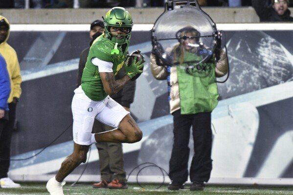 Oregon wide receiver Troy Franklin (11) carries a reception for a touchdown against Oregon State during the first half of an NCAA college football game Friday, Nov. 24, 2023, in Eugene, Ore. (AP Photo/Mark Ylen)