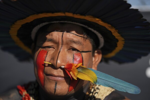 An Indigenous man protests against the auction of dozens of oil blocks, including blocks near the mouth of the Amazon River, in Rio de Janeiro, Tuesday, June 17, 2025. (AP Photo/Silvia Izquierdo)